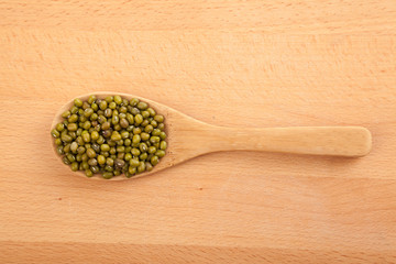 Mung beans with wooden spoon