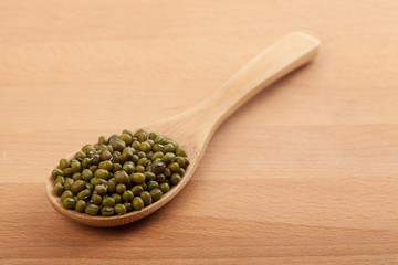 Mung beans with wooden spoon