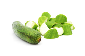 raw chopped luffa cylindrica on white background