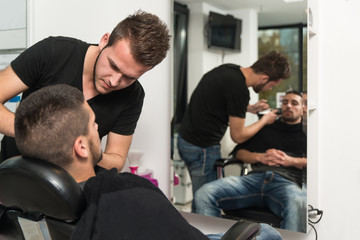 Hairdresser Shaving Man's Chin With A Straight Razor