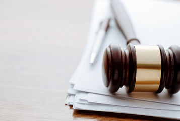 Gavel, ball pen and paper for notes on desktop