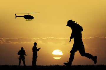 Fototapeta na wymiar soldiers silhouette at sunset
