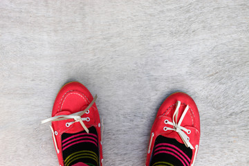 top view of red worn girl shoes over wooden textured background  - Powered by Adobe
