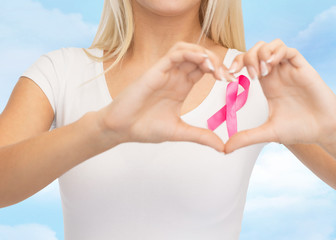 close up of woman and pink cancer awareness ribbon