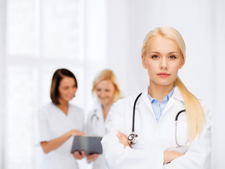 Fototapeta premium serious female doctor with stethoscope