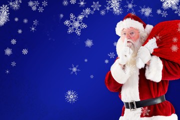 Composite image of santa claus carrying sack