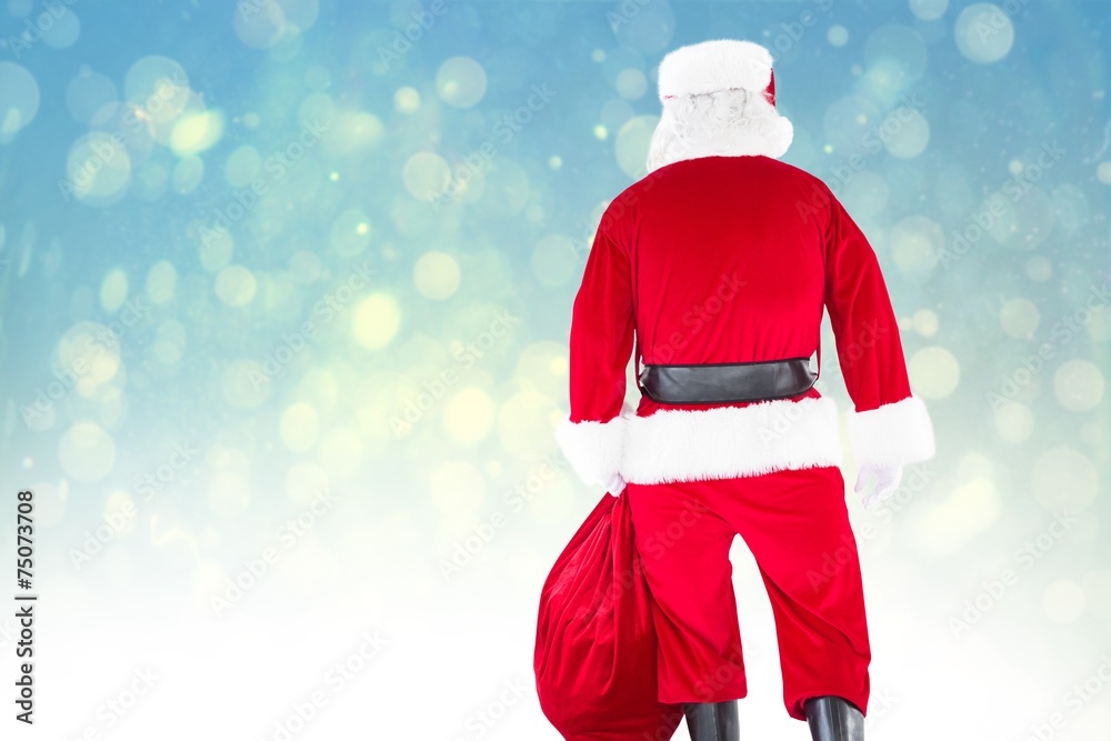 Poster composite image of rear view of santa claus holding a sack