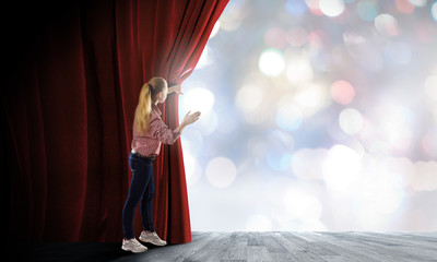 Girl opening curtain