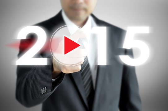 Businessman pointing  to 2015 on virtual screen