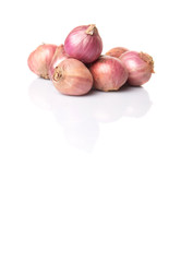 Indian small red onions over white background 