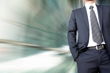 Businessman with suit & tie on fast moving motion blur backgroun