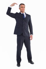 Cheerful businessman posing with arm up