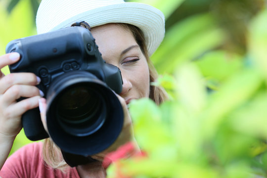 Woman photographer taking picture of nature