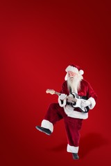 Composite image of santa claus has fun with a guitar