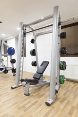 Fototapeta na wymiar Weight-lifting bench in hotel fitness center 