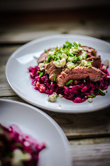Beefsteak wih beets on wooden background