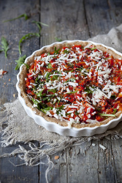 red peppers tart with rocket and parmesan on quiche mold
