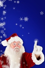 Composite image of santa claus pointing