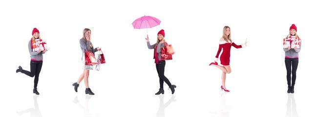 Composite image of festive blonde holding pile of gifts