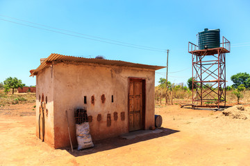 House with water tank in a village in Africa