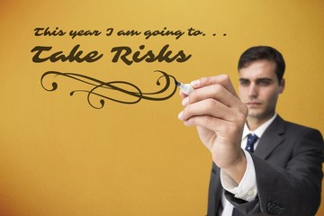 Composite image of concentrated businessman holding red marker