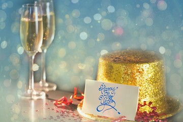 Happy new year card leaning on gold party hat