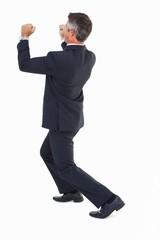 Businessman in suit pushing with his fists