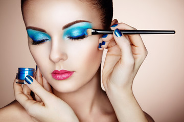 Makeup artist applies eye shadow