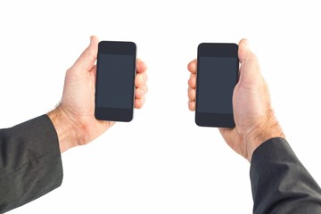 Businessman holding two smart phones