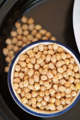 Overhead view of bowl filled with chick peas inside a tagine