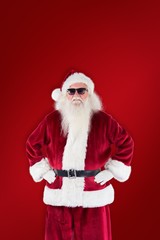 Composite image of santa claus wears black sunglasses