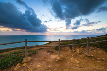 Fototapeta premium Wooden fence on the edge of Europe. Sunset. tinted