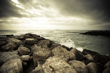 In anticipation of the storm. Dramatic sky on the stone coast of