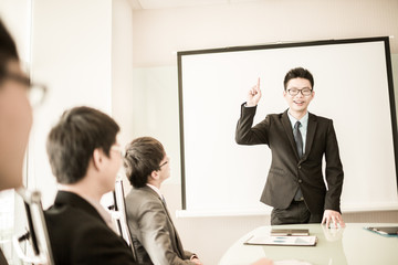 businessman giving a presentation to his colleagues