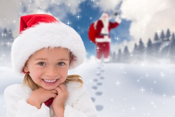 Composite image of cute little girl wearing santa hat