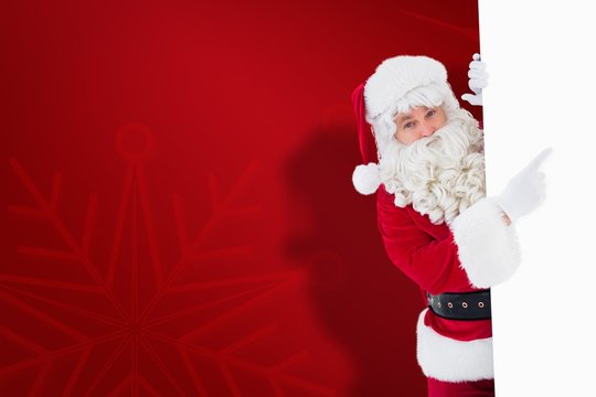 Composite image of smiling santa claus pointing poster