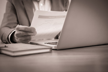 Businessman analyzing investment charts with laptop. Accounting
