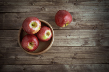 apples in a wooden saucer