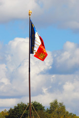 Old French state flag tricolor. Blue sky background.