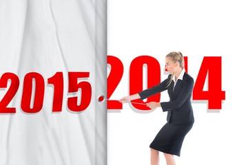 Composite image of focused blonde businesswoman pulling a rope