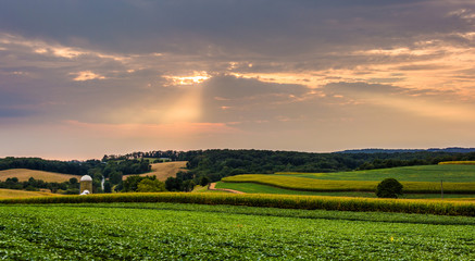 Sunset over farm fields and rolling hills in rural York County,