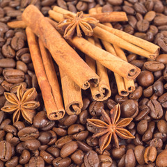 Obraz na płótnie Canvas Lots of coffee beans. Three anise stars, lots of sticks of cinna