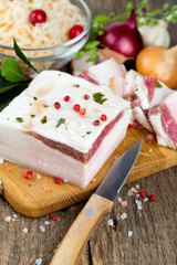 salted lard and spices on wooden surface