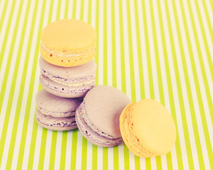 Tasty macaroons on green striped background
