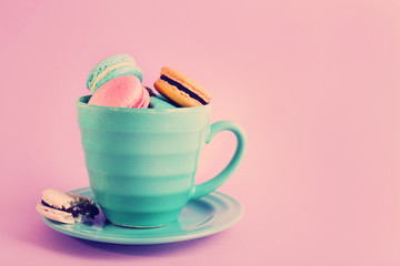 Assortment of gentle colorful macaroons in mug