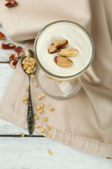 Tasty dessert with oat flakes and honey, on table