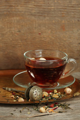 Beautiful vintage composition with herbal tea, on wooden table