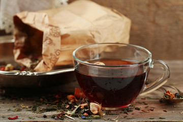 Beautiful vintage composition with herbal tea, on wooden table