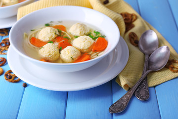 Soup with meatballs and noodles in bowls