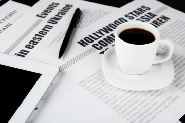 On-line news concept. Computer mouse, PC tablet, cup of coffee